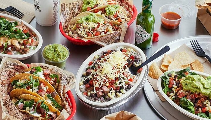 Plates of Chipotle burritos, tacos, and salad