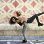 Laughing woman carrying her best friend piggyback