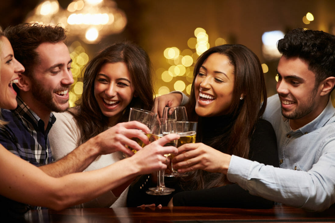 Group Of Friends Enjoying Evening Drinks In Bar