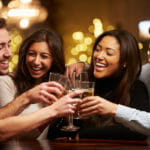 Group Of Friends Enjoying Evening Drinks In Bar