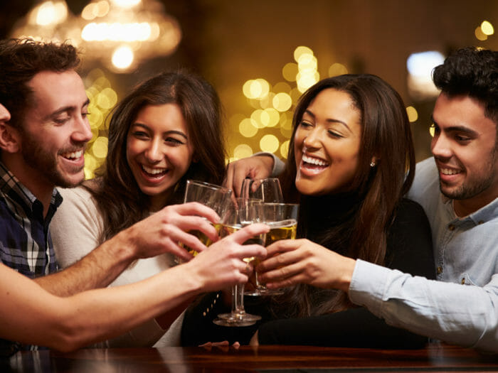 Group Of Friends Enjoying Evening Drinks In Bar