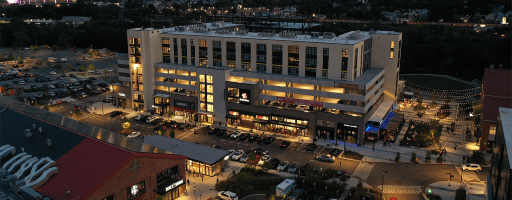 aerial view of parking structure and parking lot at night